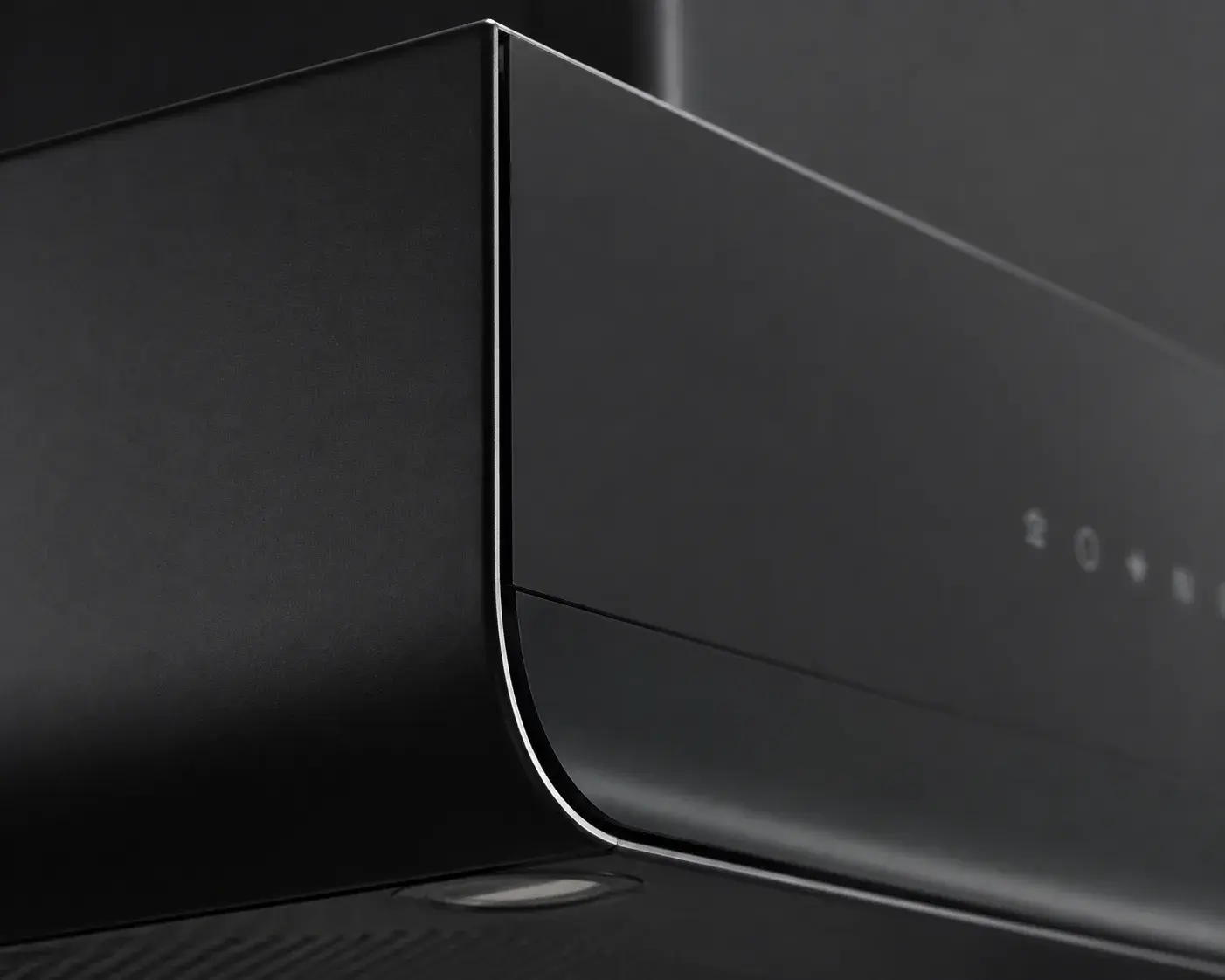 Matte black chimney body meeting curved glass, close detail